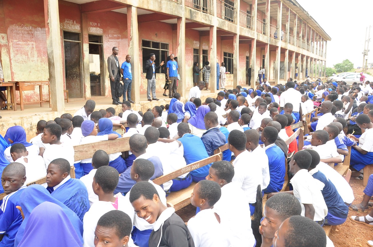 Addressing a full school assembly during a mental health awareness visit.