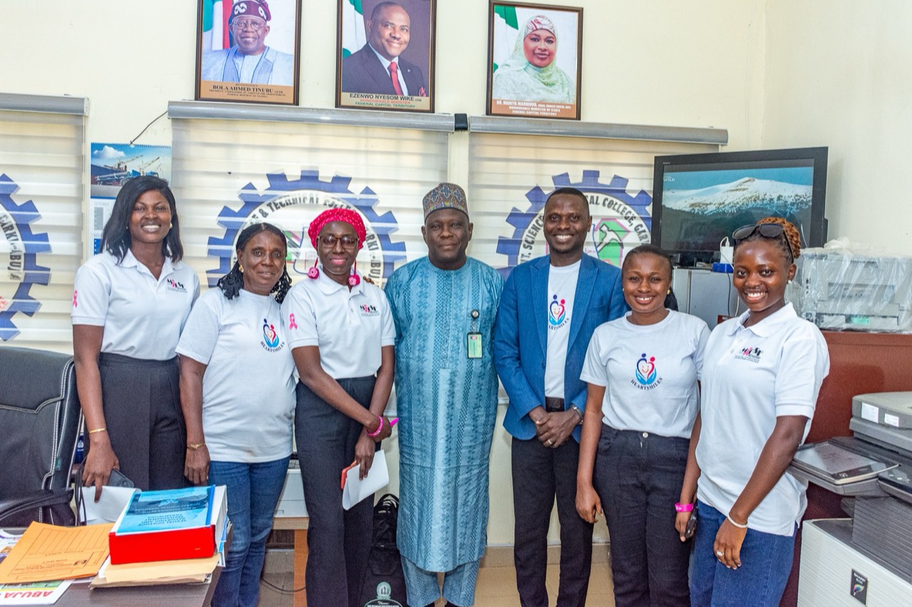 The Heartsmiles team with the principal in the principal's office.
